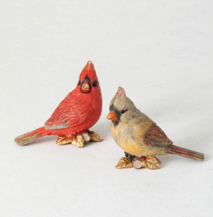 A charming and delightful tabletop accessory, this pair of a male and female cardinal figurines stand 4.5" tall. Resting atop golden leaves, these polyresin sculptures make a perfect addition to a bookshelf or side table.